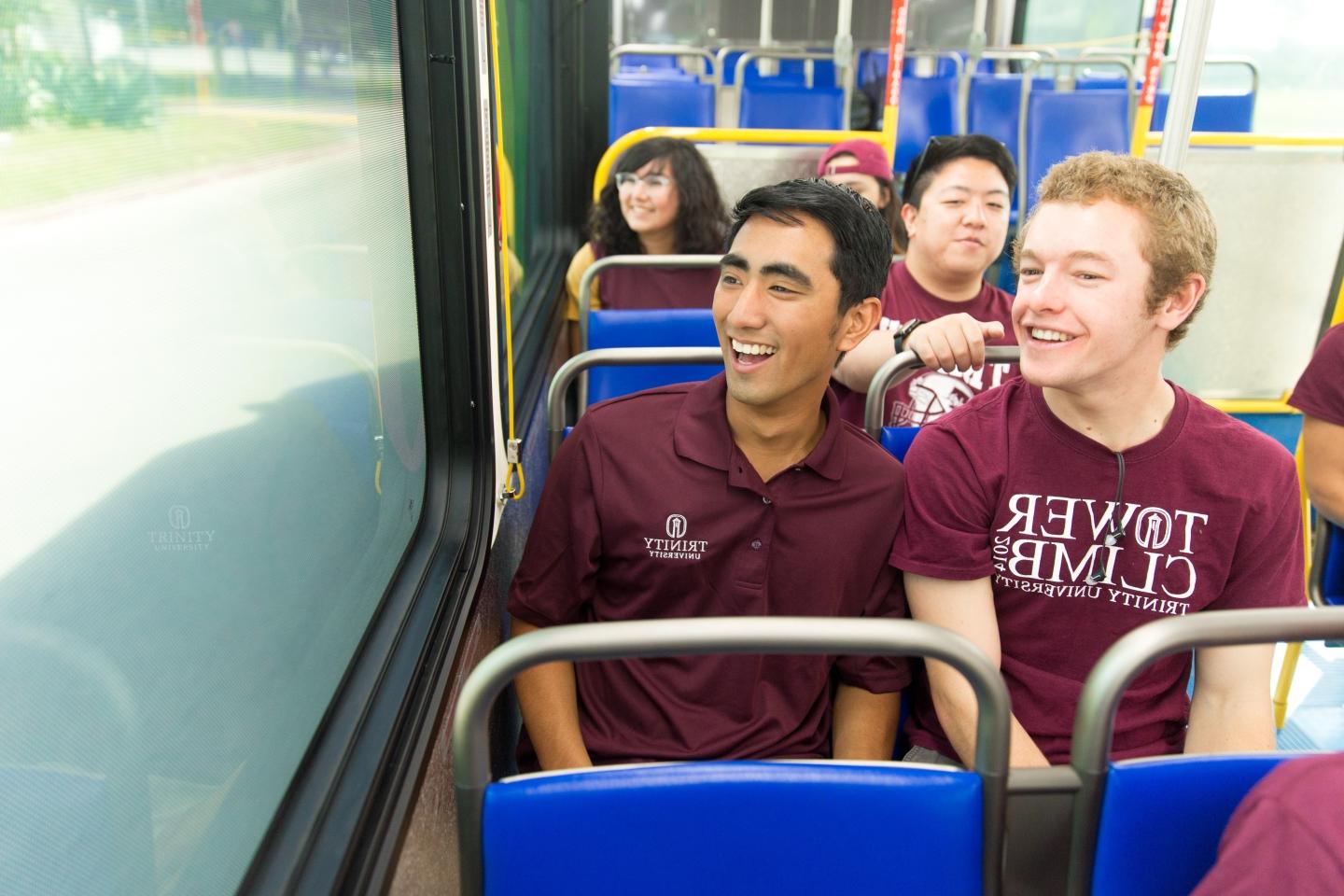 一群学生乘坐VIA公共汽车，城市从窗外经过